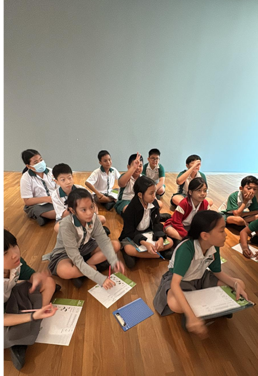 Students participating in a classroom discussion during an arts lesson.